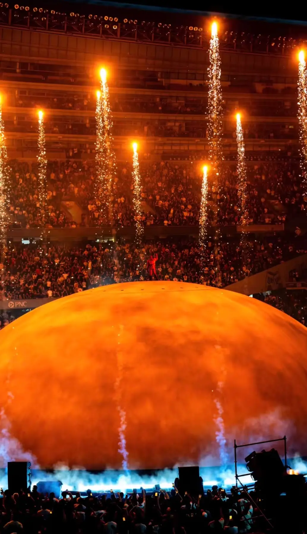 A concert arena filled with orange lights
